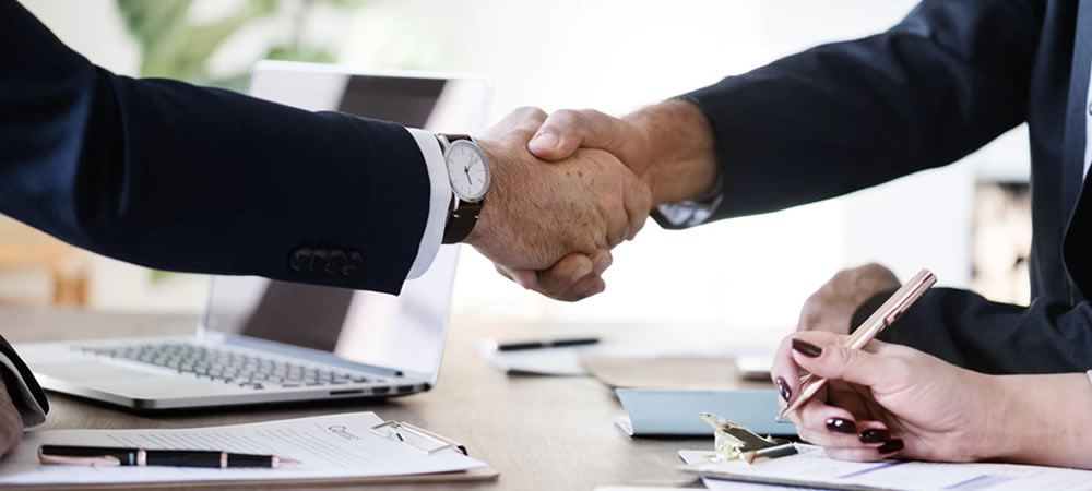 Photo of two people shaking hands