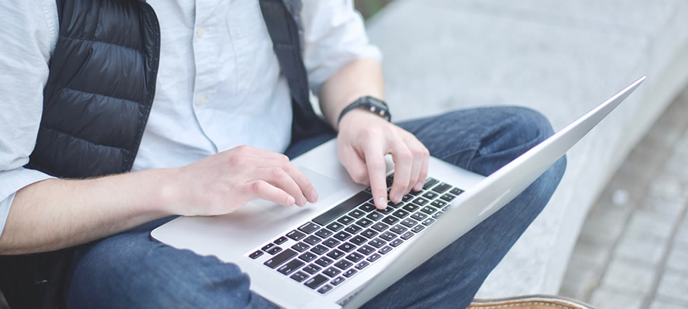 Photo of man using laptop