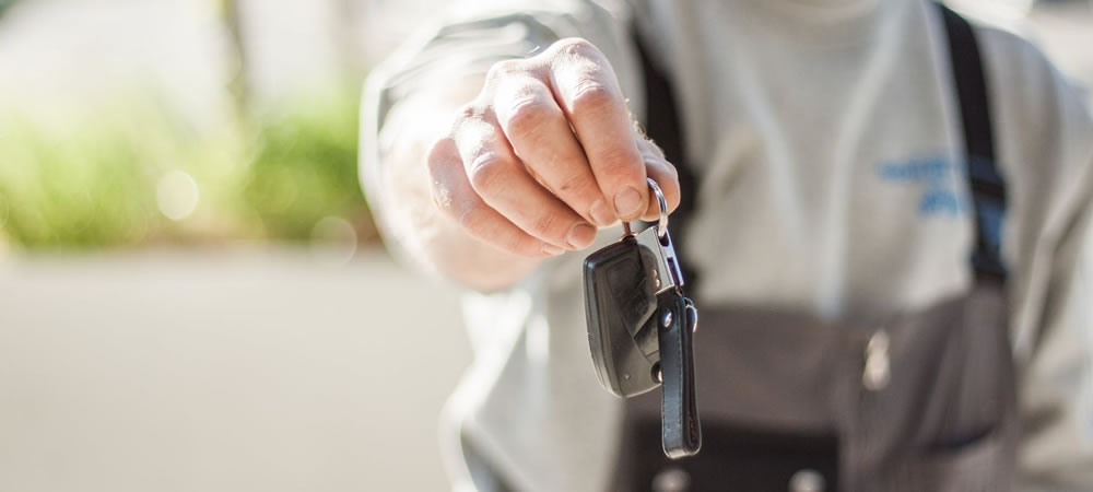 Photo of man handing over keys